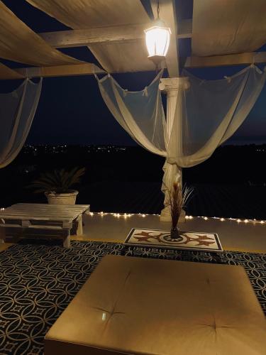 a room with a table and a lamp on a balcony at L'incanto di Nausicaa in Ascea