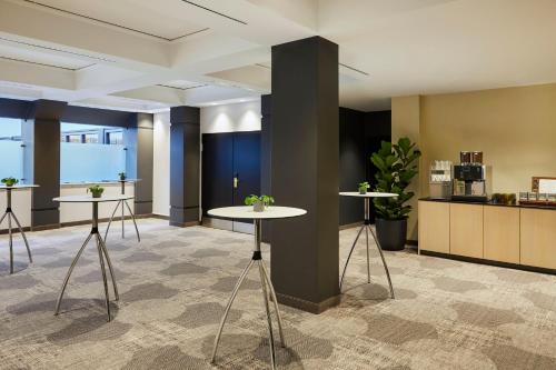 a lobby with two tables with plants on them at Crowne Plaza Hamburg-City Alster by IHG in Hamburg