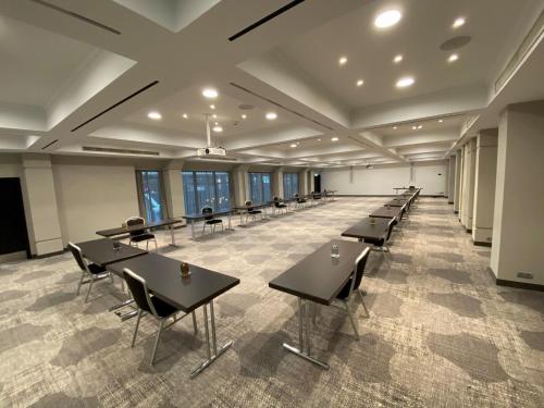 a large room with tables and chairs and windows at Crowne Plaza Hamburg-City Alster by IHG in Hamburg