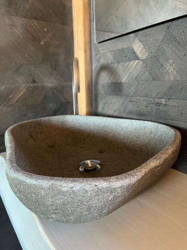a stone sink sitting on a counter in a bathroom at MonteSoprano Agriturismo - Resort - Spa - Gym -Camping - Suite in Capizzi