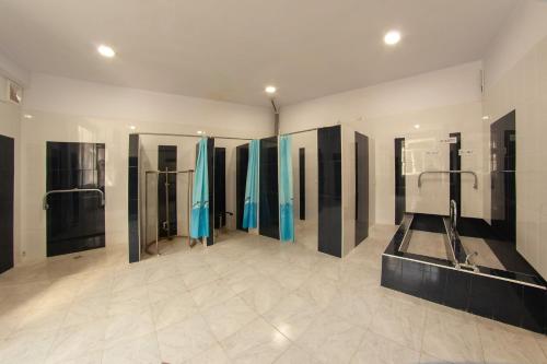 a large bathroom with blue shower stalls in it at Vanadzor Armenia Hotel in Vanadzor
