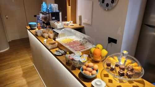 a kitchen counter with many bowls of food on it at EVA LUXURY ROOMS CAGLIARI in Cagliari
