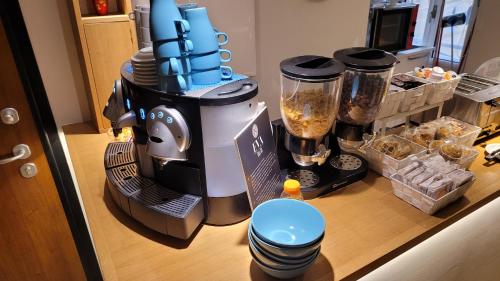 a kitchen counter with a blender on a table at EVA LUXURY ROOMS CAGLIARI in Cagliari