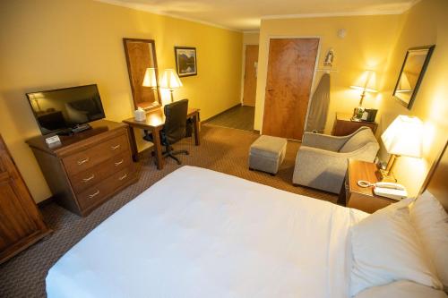 a hotel room with a bed and a television at Best Western of Lake George in Lake George