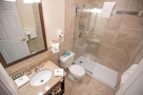 a bathroom with a toilet and a sink and a shower at Best Western of Lake George in Lake George