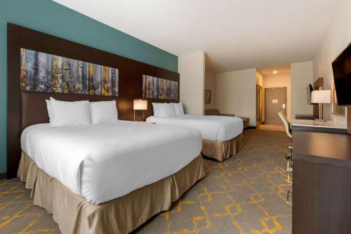 a hotel room with two beds and a television at Best Western Plus Isanti in Isanti