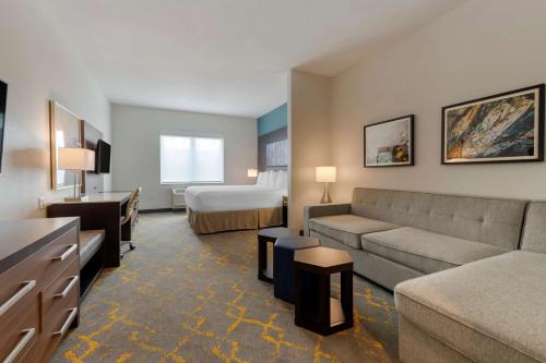 a hotel room with a couch and a bed at Best Western Plus Isanti in Isanti