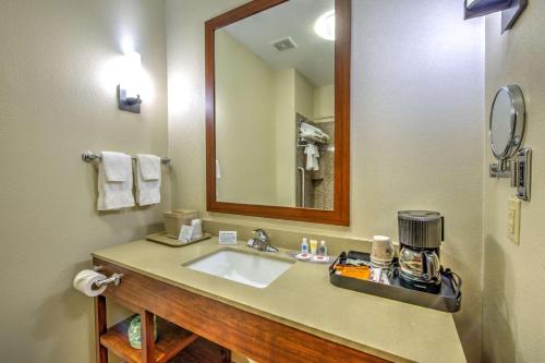 a bathroom with a sink and a mirror at Comfort Suites Tomball Medical Center in Tomball