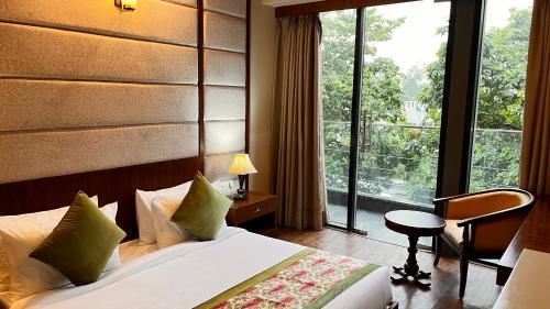 a hotel room with a bed and a large window at IP Royal Hotel - New Delhi in New Delhi