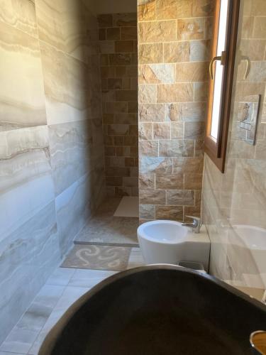 a bathroom with a tub and a toilet and a sink at MonteSoprano Agriturismo - Resort - Spa - Gym -Camping - Suite in Capizzi