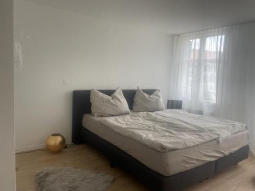 a bed with white sheets and pillows in a bedroom at Appartment- Suite im Hotel Krone mit Seeblick in Heiden