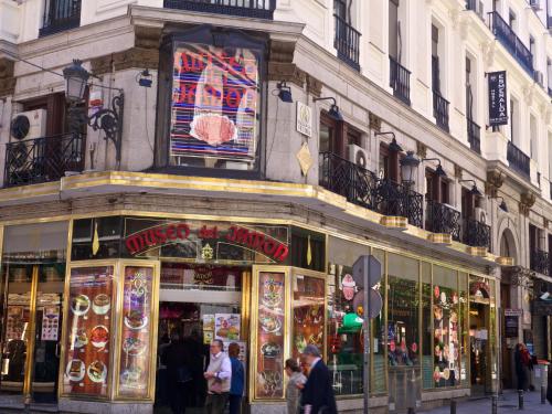 a building with people walking in front of a store at Hostal Esmeralda in Madrid