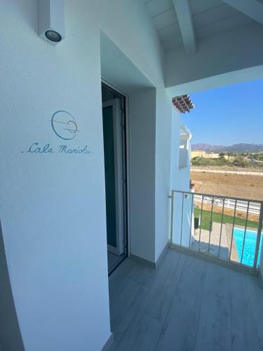 a room with a balcony with a view of a pool at Villa Lentischio in Budoni