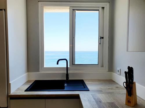 a kitchen with a sink and a window at Estepona Vistamar 3 bedrooms in Estepona