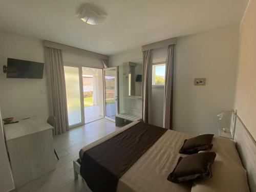 a bedroom with a large bed with two pillows on it at Villa Lentischio in Budoni