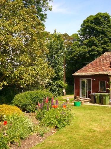 a house with a yard with flowers in the yard at Stable Lodge B&B in Petham