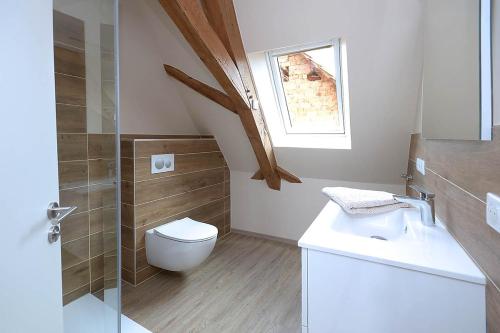 a bathroom with a toilet and a sink and a window at Remise 67 - Historisches Anwesen beim Maison 1775, mit Sauna, Wissembourg, Elsass in Ingolsheim
