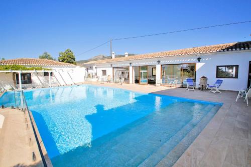 a swimming pool in front of a house at Magnificient Rural Home With Pool and BBQ in Alicante