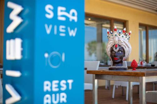 a statue of a woman with a crown on her head at Hotel Riva Del Sole in Cefalù