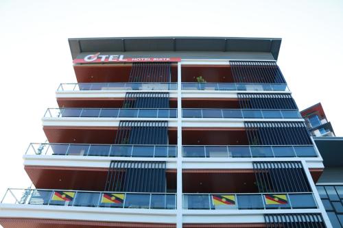 a tall building with lots of windows at OTEL Hotel Suite in Sibu