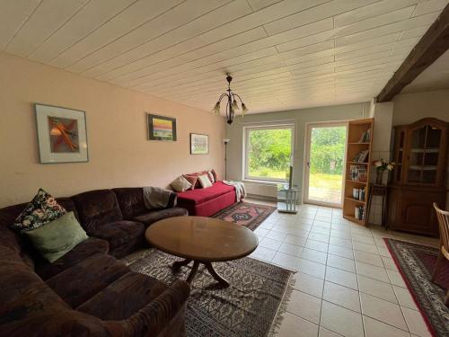 a living room with a couch and a table at Landhaus Huntlosen Monteure in Großenkneten