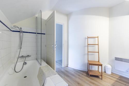 a white bathroom with a shower and a ladder at La Savariere Gite campagne et plage pour 12 in Landevieille