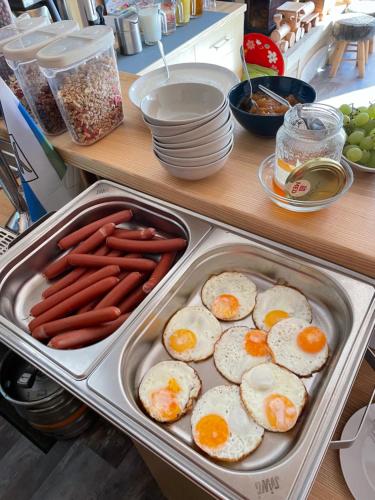 a tray of eggs and carrots in a kitchen at penzion Valentino in Bedřichov