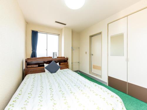 Postel nebo postele na pokoji v ubytování Tabist Business Hotel Chitose Kashiwazaki