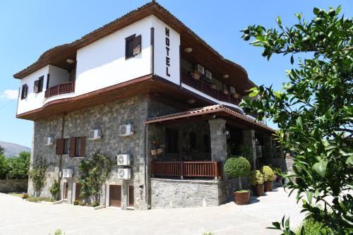 a large stone building with a roof at Hotel Kaceli in Berat
