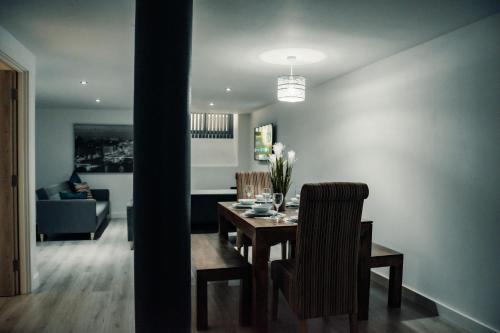 a dining room and living room with a table and chairs at Bv Comfy Basement Apartment At Conditioning House in Bradford