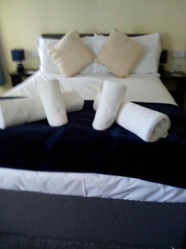 a bed with white pillows and socks on it at THE KINGS ARMS INN in Stratton