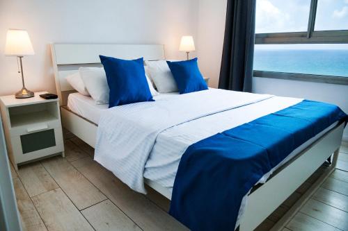 Almog Beach Apartments מגדלי חוף הכרמל חיפהにあるベッド
