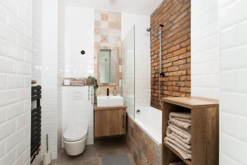 a bathroom with a sink and a toilet and a tub at Industrial Studio in Budapest