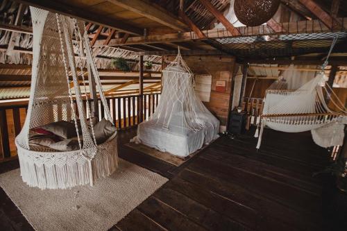 a room with two hammocks in a house at Bayano Ecolodge in Chepo