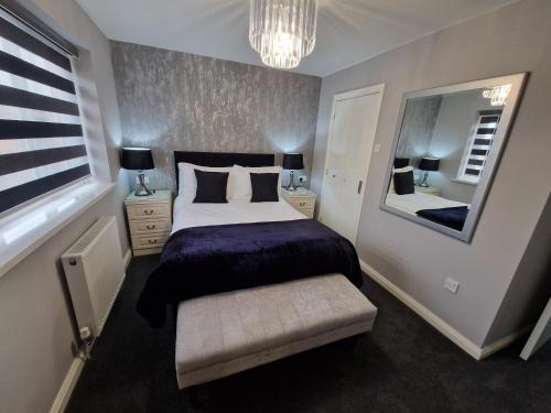 a bedroom with a large bed and a mirror at Corner House at L3 in Liverpool
