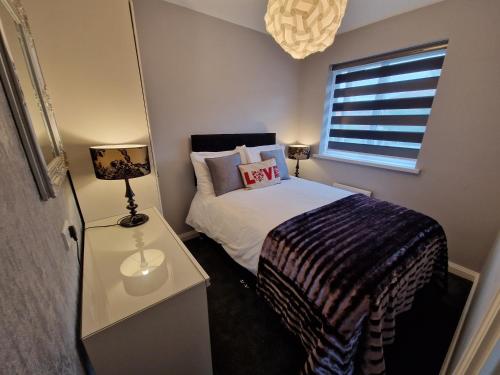 a small bedroom with a bed and a window at Corner House at L3 in Liverpool