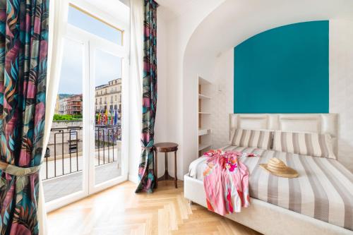 a bedroom with a bed and a large window at SORRENTO - Posizione unica nella piazza principale in Sorrento