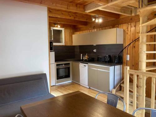 a kitchen with a table and a counter top at Maglines in Vars