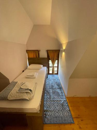 a bedroom with two beds in a attic at Konačište Osmica in Mokra Gora