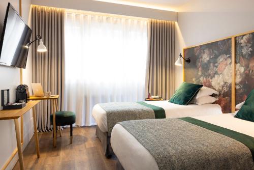 Un ou plusieurs lits dans un hébergement de l'établissement Hôtel Edmond W Lyon Part-Dieu