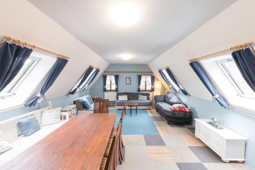 a living room with a table and a couch at Pension Rokytka in Kryštofovo Údolí