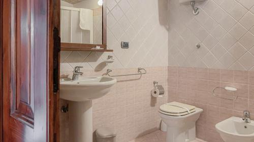 a bathroom with a toilet and a sink at Borgo San Valentino in Arrone