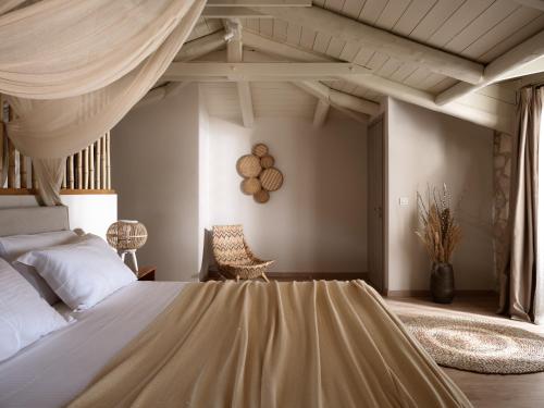 a bedroom with a large bed with a canopy at Conte Nobile Villa, a Rejuvenating Retreat, By ThinkVilla in Vasilikos
