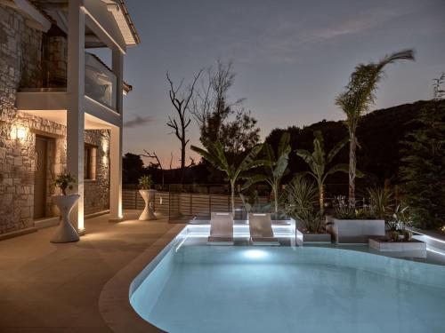 a swimming pool in the middle of a house at Conte Nobile Villa, a Rejuvenating Retreat, By ThinkVilla in Vasilikos