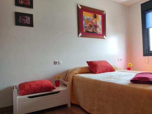 a bedroom with two beds and a painting on the wall at Apartamento Agarimo - La tranquilidad de una isla de menos de 5000 habitantes in Isla de Arosa