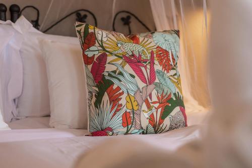 a pillow sitting on top of a bed at Umkumbe Bush Lodge - Luxury Tented Camp in Sabi Sand Game Reserve