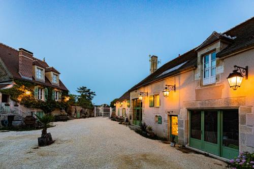 an empty street in a village with buildings at Le Domaine des Carriers in Chevroches