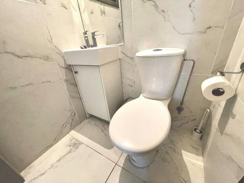 a white bathroom with a toilet and a sink at Demetra 1 Bdr Down Town Nicosia in Nicosia
