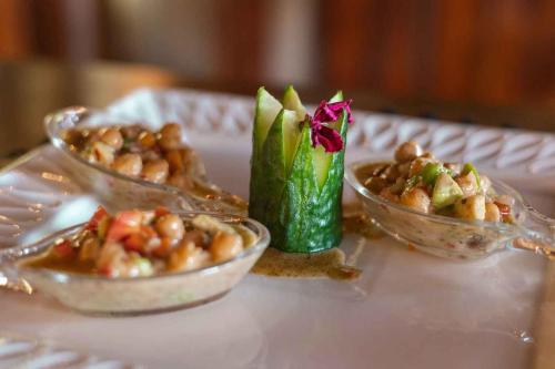 a table with two dishes of food on a table at Umkumbe Bush Lodge - Luxury Tented Camp in Sabi Sand Game Reserve