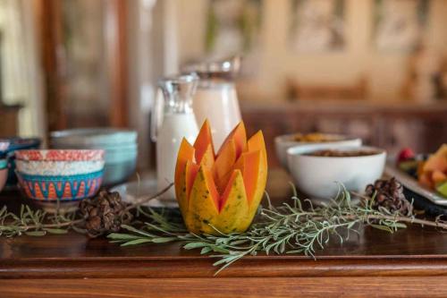a wooden table with a flower decoration on it at Umkumbe Bush Lodge - Luxury Tented Camp in Sabi Sand Game Reserve